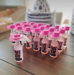 many pink bottles are lined up on the table