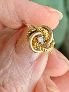 This wonderful ring started life as a Victorian-era stick pin, which I converted into a ring. It's crafted of 10K yellow gold with a central opal, and it's in the classic love-knot motif. The opal in the center may be small, but it's a richly colored and beautiful one. The ring is an easily resized 4.75 in 10K gold. You can see the 10k stamp on the exterior of the band in one photo, which can professionally buffed out if you don't want it visible. Free shipping in the US. If you live elsewhere, Jelly Opal, Opal Band, Moonstone Engagement, Opal Ring Gold, Moonstone Engagement Ring, One Photo, Love Knot, Stick Pins, Vintage Victorian