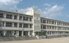 the building has many windows and balconies on each floor in front of it