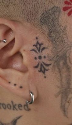 a close up of a person with tattoos on their ear and behind the ear tattoo