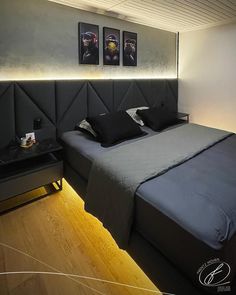 a bed with black sheets and pillows in a room