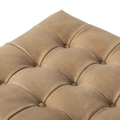 an upholstered brown leather bench cushion