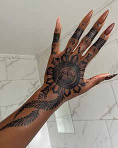 a woman's hand with tattoos on it and the palm of her left hand