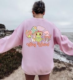 "Stay Weird Mushroom Sweatshirt, Stay Weird Sweater, Nature Mushroom Shirt, Magic Mushroom Hoodie, Psychedelic Shirt, Mushroom Hippie Hoodie Message for any details please!  ☀️☀️☀️☀️☀️ Everything in our shop is hand crafted and made to order. If you want different color or size contact me! If you would like something custom made to fit your personal style please message me and I will do everything to get you that something special. ---How To Order--- ⭐️Please, check and review all photos ⭐️Choose your t-shirt size and color ⭐️Enter your Design Color Example: \"White\" ⭐️Click add to cart. You can go back to add more product ⭐️Click \"Proceed to check out\" ⭐️When you check out, you can add a note to seller for any request *High quality and super soft, comfortable shirt. Made with top of th Casual Fall Sweatshirt With Mushroom Print, Casual Mushroom Print Sweatshirt For Fall, Casual Crew Neck Sweatshirt With Mushroom Print, Casual Long Sleeve Top With Mushroom Design, Cotton Sweatshirt With Mushroom Print, Cotton Long Sleeve Sweatshirt With Mushroom Print, Mushroom Sweatshirt, Mushroom Hoodie, Hippie Hoodie