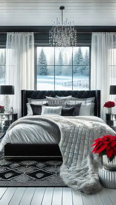 a bedroom decorated in black and white with red poinsettis on the bed