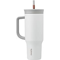 a white coffee cup with a handle on the side and an orange straw sticking out of it