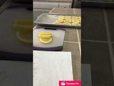 there are lemons on the counter ready to be cut into small pieces and put in trays