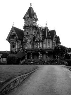 an old house with a steeple on the top and a large driveway leading up to it