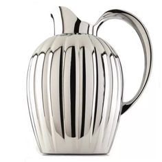 a silver pitcher with black stripes on the bottom and sides, sitting in front of a white background