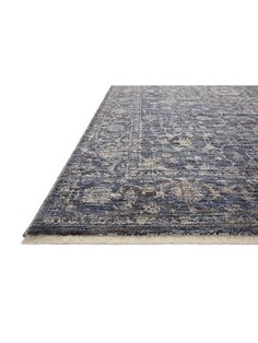 a blue and beige area rug on a white background