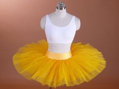 a mannequin wearing a yellow tutu and white tank top on a dummy