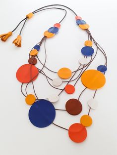 HANDMADE  LEATHER NECKLACE  MULTI-STRAND LEATHER NECKLACE WITH DOUBLE CIRCLES              -DETAILS LENGTH: necklace about 50 cm long. The lanyard is adjustable in various lengths. MATERIALS: leather and waxed cord  -DESCRIPTION Necklace made up of 6 strands of cord with double  leather circles of various sizes (from 1 to 4 cm in diameter). The leather is very soft and the colors are bright It has a clean and refined style and is handmade with soft and precious Italian leather carefully selected Bold Multicolor Adjustable Necklace, Adjustable Multicolor Bib Necklace, Bohemian Multicolor Enamel Necklaces, Handmade Leather Necklaces, Bohemian Multicolor Enamel Necklace, Artisan Multi-strand Red Necklaces, Length Necklace, Bib Necklaces, Elegant Necklaces