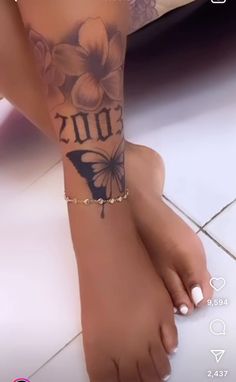 a woman's foot with a butterfly tattoo on her left arm and the word 2010 written in black ink