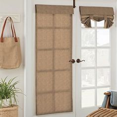 a living room with a chair and window in front of the door that has blinds on it