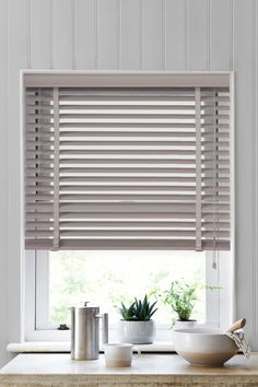 a kitchen window with blinds in it