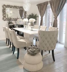 a dining room table with chairs and a chandelier