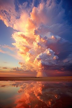 the sky is reflected in the water as it looks like clouds are coming from behind