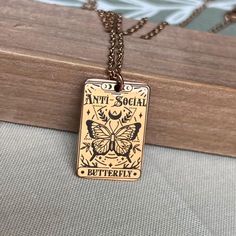 "Embrace your unique style with our Personalized Anti-Social Butterfly Necklace. This one-of-a-kind necklace features the captivating \"Anti-Social Butterfly\" design that represents your individuality and charm. Engraved on high-quality stainless steel, it comes in elegant gold, silver, and rose gold colors, ensuring a timeless and durable piece of jewelry. Express yourself confidently as this necklace is waterproof and anti-tarnish, ready to accompany you on all your adventures. Whether it's a Symbolic Rose Gold Tarnish-resistant Necklaces, Symbolic Rose Gold Tarnish Resistant Necklace, Symbolic Rose Gold Tarnish-resistant Necklace, Symbolic Gold Copper Necklace, Symbolic Rose Gold Necklace As Gift, Symbolic Rose Gold Necklace, Rose Gold Brass Charm Necklace As Gift, Rose Gold Brass Charm Necklace For Gift, Personalized Gold Copper Necklace