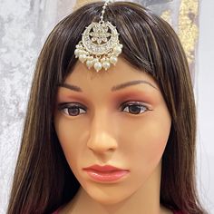 a mannequin head wearing a hair piece with pearls on it's head