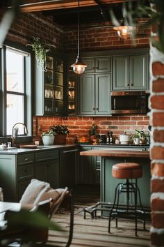 a kitchen with green cabinets and stools next to a brick wall that has potted plants on it