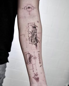 a person with a tattoo on their arm holding a piece of paper in his hand