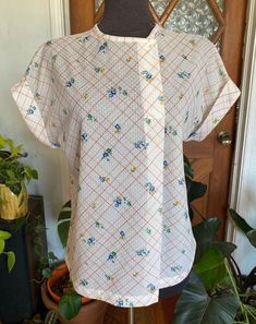 "Vintage 70s semi-sheer woven blouse by Devon. Union Made. Feels like polyester.  Excellent vintage condition! No stains or holes. Always use measurements for more accurate sizing. Tag labels are meaningless. Measurements taken laying flat/Double number where applicable: ARMPIT TO ARMPIT: 19.5\" SLEEVE: 1.5\" inseam, 7.5\" width  LENGTH: 24.5\" ALL SALES ARE FINAL SO PLEASE DOUBLE CHECK THE MEASUREMENTS PRIOR TO BUYING AND DON'T HESITATE TO REACH OUT IF YOU HAVE ANY QUESTIONS!  All items are vintage/preloved and may have small imperfections. This should be expected for secondhand clothing. ALL MAJOR FLAWS WILL BE NOTED IN THE DESCRIPTION AND PHOTOGRAPHED." 1970s Style Cotton Tops With Short Sleeves, Double Numbers, 1970s Vintage Print Cotton Tops, 1970s Retro Print Cotton Top, 1970s Cotton Short Sleeve Tops, 1970s Long Sleeve Cotton Shirt, Union Made, Second Hand Clothes, Tube Top