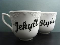 two coffee cups with the words jekyll hyde printed on them sitting side by side