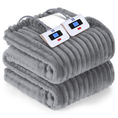 two heated blankets stacked on top of each other with thermometers attached to them