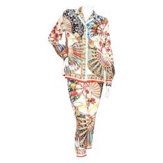 Product Details: Silk print pant suit by Dolce & Gabbana Multicolor print Fan print with Sicilian figures Blouse: Pointed collar Long sleeve Button closure cuffs Button front closure Fluid silhouette Pant: Mid rise Flat front Fitted legs Zip side with hook and eye closure Made in Itay Condition: Good, some loose strings. Pulls in fabric throughout. Sold as is. (see photos) Size/Measurements: Size 42IT 38" bust 39" waist 25.5" length Pant: 27" waist 30" hip 34" pant length Designer Long Sleeve Sets For Spring, Multicolor Long Sleeve Sets For Workwear, Multicolor Long Sleeve Sets For Work, Multicolor Long Sleeve Sets For Daywear, Spring Multicolor Digital Print Sets, Patterned Long Sleeve Printed Sets, Multicolor Floral Print Long Sleeve Set, Long Sleeve Digital Print Sets For Work, Multicolor Long Sleeve Floral Print Set