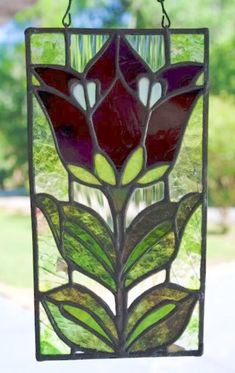 a stained glass flower hanging from a window