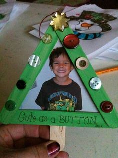 a child's christmas tree ornament made out of wood with buttons on it