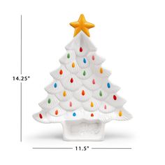 a white ceramic christmas tree with multicolored lights and a gold star on top