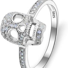 a white gold skull ring with diamonds on the sides and an inscription that says love