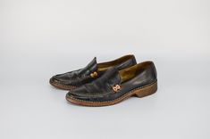 Step into classic elegance with these Vintage All Leather Loafers in Black by Sergio Rossi. Made in Italy, these retro slip-on shoes feature a plain toe and a chunky low heel, combining style and comfort. The all-leather construction with a tan leather detail adds a sophisticated touch, making them perfect for any occasion. Elevate your wardrobe with these timeless loafers that offer a blend of vintage charm and modern sophistication. Brand: Sergio Rossi | Made in Italy Condition: USED. Some sta Sergio Rossi Shoes Mocassin, Slip On Shoes For Women, Vintage Loafers, Womens Loafers, Leather Detail, Sergio Rossi, Classic Elegance, Shoes For Women, Leather Loafers