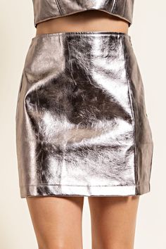 High Waist Faux Leather Mini Skirt Brand: Glam Style: GP6651 Fabric: 50% PU 50% POLYESTER Details: High Waist Faux Leather Mini Skirt*Zipper on the side*Matching top: GT6653MODEL HEIGHT: 5' 7" SELF: 50% PU 50% POLYESTER Made in China Trendy Shiny Mini Skirt, Chic Metallic Mini Skirt, Metallic Lined Skirt For Fall, Fall Metallic Lined Skirt, Party Faux Leather Skirt With Side Zipper, Confident Style, Skirt Zipper, Faux Leather Mini Skirt, Glam Style