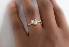 a woman's hand with a diamond ring on it