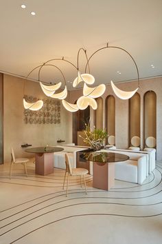 an elegant dining room with modern lighting fixtures