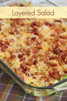 layered salad in a glass dish with cheese and bacon