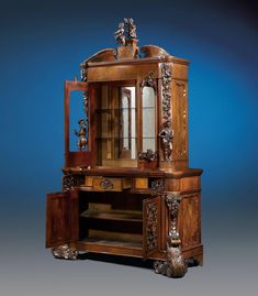 an ornate wooden cabinet with glass doors and carvings on the front, against a blue background