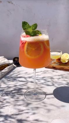 a glass filled with liquid sitting on top of a table