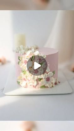 the cake is decorated with flowers and candles