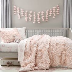 a bed with pink comforters and pillows in a room