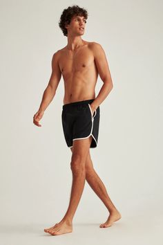 a man in black and white swim trunks