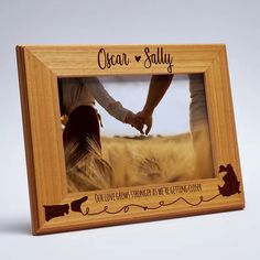 a wooden frame with an image of two people holding hands