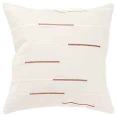 a white pillow with gold lines on the front and back, along with a brown stripe down the middle