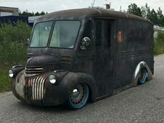 an old truck is parked on the side of the road