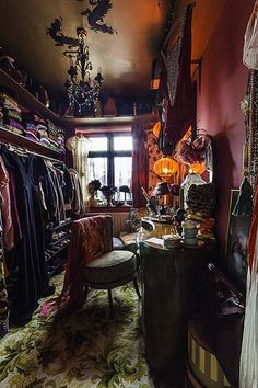 a room filled with lots of clothes and furniture