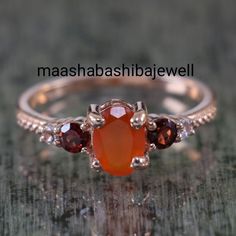 "Natural Carnelian Ring, Garnet Ring, Multi Gemstone Rings, Stacking Ring, 925 Sterling Silver, Birthday Gift, Engagement Ring, Ring For Her SHOP LINK:- https://www.etsy.com/shop/MaaShabashibaJewell?ref=seller-platform-mcnav 》D E T A I L S《 Gemstone: 1) Natural Carnelian 2) Natural Garnet 3) White Topaz Gem Color: 1) Orange 2) Red 3) White Gem Shape: 1) Oval 2) Round 3) Round Gem Size: 1) 5x7mm 2) 3x3mm 3) 2x2mm Metal: 925 Sterling Silver Purity: 925 Parts Per 1000 Setting Type: Prong Set Silver Orange Garnet Ring, Oval Carnelian Moonstone Ring For Anniversary, Orange Ruby Ring For Anniversary, Anniversary Orange Ruby Ring, Orange Multi-stone Round Rings, Anniversary Orange Rings With Gemstone Accents, Amber Gemstone Ring For Anniversary, Oval Carnelian Wedding Rings, Anniversary Amber Gemstone Ring