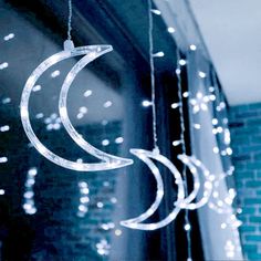 some lights hanging from the side of a building with a crescent and stars on it