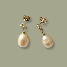 Elevate your bridal ensemble with our exquisite Freshwater Pearl Drop Earrings.  Add timeless elegance to any wedding look. Perfect as bridal pearl earrings or a thoughtful bridesmaid gift, they combine sophistication with a touch of luxury, ensuring a memorable celebration. Gold Drop Earrings For Wedding Gift, Pearl Drop Briolette Earrings For Wedding, Handmade Teardrop Bridal Earrings For Wedding, Yellow Gold Dangle Bridal Earrings For Wedding, Yellow Gold Dangle Earrings For Wedding, Delicate Briolette Earrings For Wedding, Handmade Pear-shaped Jewelry For Wedding, Elegant Briolette Pearl Earrings For Wedding, Elegant Briolette Earrings For Wedding